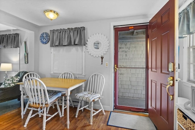 dining room with baseboards and wood finished floors