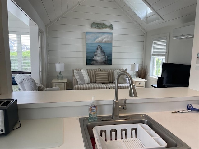 17 Hydrangea Ln Unit 786, Mashpee, MA 02649 - kitchen featuring lofted ceiling, a sink, a wall mounted air conditioner, and wood walls