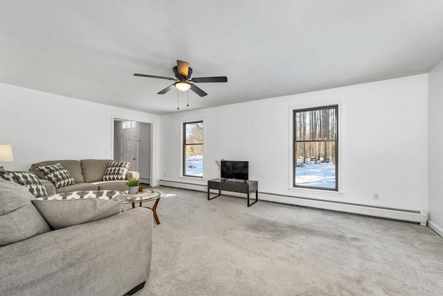 living room featuring carpet flooring, a baseboard radiator, baseboard heating, and ceiling fan