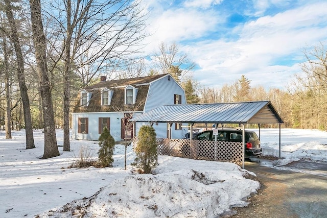 dutch colonial with a gambrel roof, a chimney, and a shingled roof