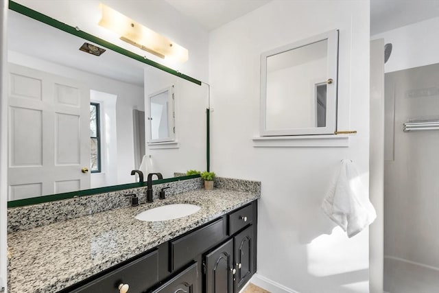 bathroom featuring vanity and baseboards