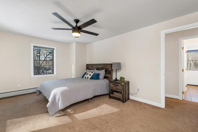 bedroom featuring carpet flooring, ceiling fan, baseboards, and a baseboard radiator