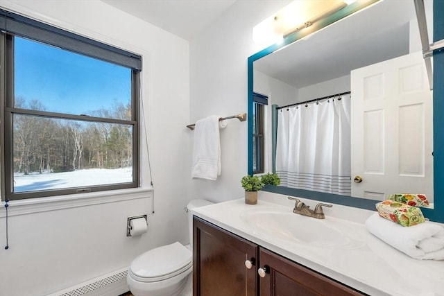 full bath with vanity, curtained shower, toilet, and a baseboard radiator