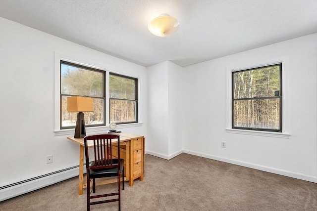 home office featuring light carpet, baseboard heating, a healthy amount of sunlight, and baseboards