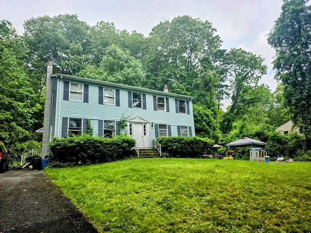 209-211 Ventura St, Ludlow, MA 01056 - colonial inspired home featuring a chimney and a front lawn