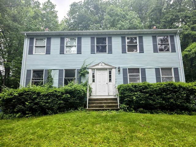 209-211 Ventura St, Ludlow, MA 01056 - colonial home with a front lawn and a chimney