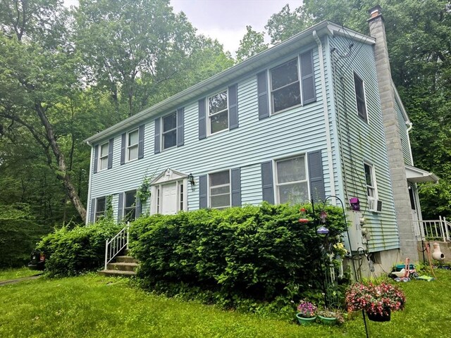 209-211 Ventura St, Ludlow, MA 01056 - colonial-style house with a chimney, a front yard, and cooling unit