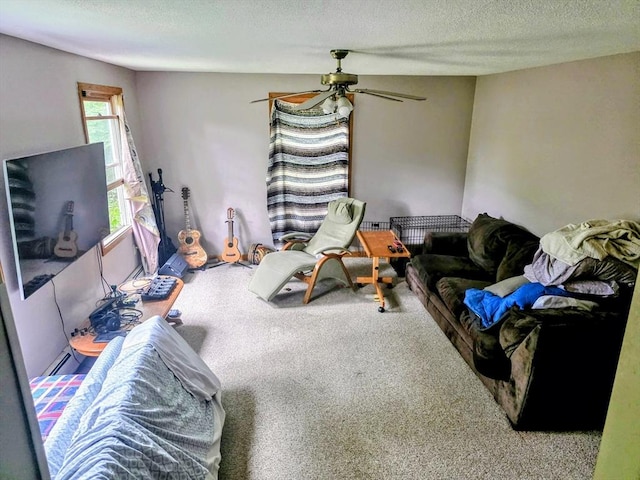 209-211 Ventura St, Ludlow, MA 01056 - carpeted living area featuring a textured ceiling, a ceiling fan, and a baseboard heating unit