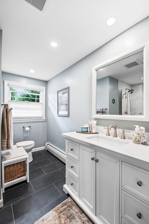 64 Pond St, Nahant, MA 01908 - bathroom with baseboard heating, vanity, tile patterned flooring, recessed lighting, and a shower