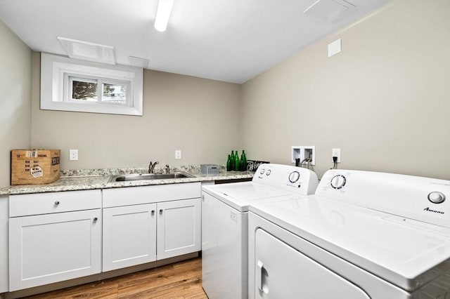 64 Pond St, Nahant, MA 01908 - laundry area with independent washer and dryer, light wood finished floors, and cabinet space