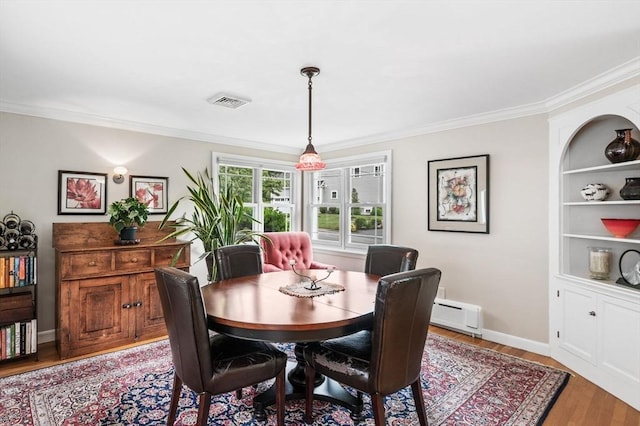 64 Pond St, Nahant, MA 01908 - dining space with light wood-type flooring, ornamental molding, and a baseboard radiator