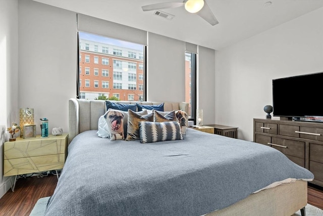 bedroom with dark hardwood / wood-style flooring and ceiling fan