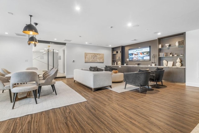 living room featuring hardwood / wood-style flooring and built in features