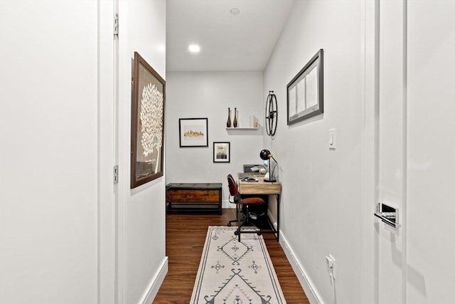 hallway with dark hardwood / wood-style flooring