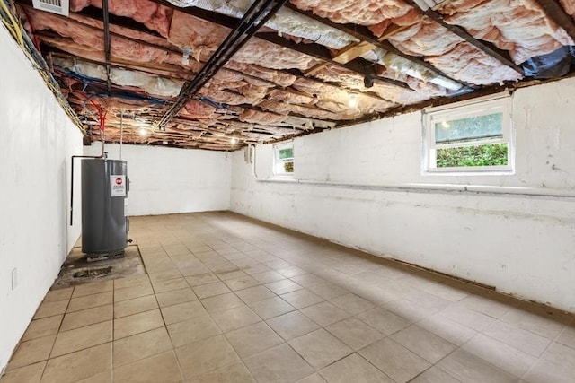 27-29 Waite St, Malden, MA 02148 - basement featuring water heater, healthy amount of natural light, and tile patterned flooring