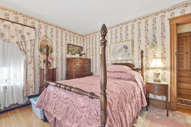 bedroom featuring wood-type flooring and wallpapered walls