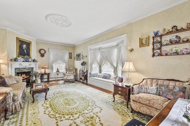living room with a baseboard heating unit, ornamental molding, a fireplace, and wood finished floors