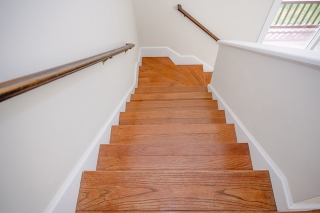 stairs with light parquet floors