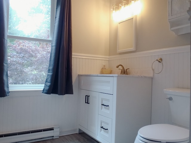 bathroom with vanity, a baseboard heating unit, and toilet