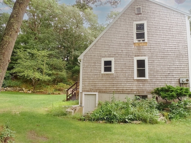 view of side of property with a yard