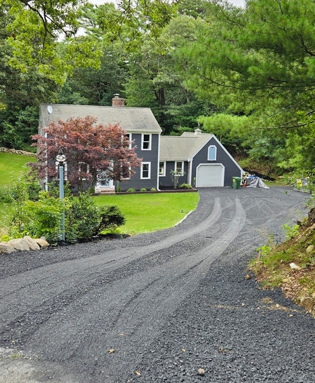 view of front of home with a garage and a front yard