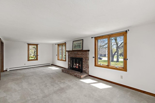 unfurnished living room featuring carpet, baseboards, a fireplace, and a baseboard heating unit