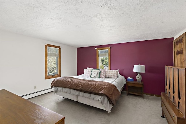 bedroom featuring light colored carpet, a baseboard radiator, a textured ceiling, and baseboards