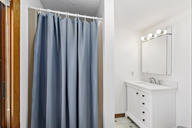 bathroom featuring vanity, baseboards, and a shower with shower curtain