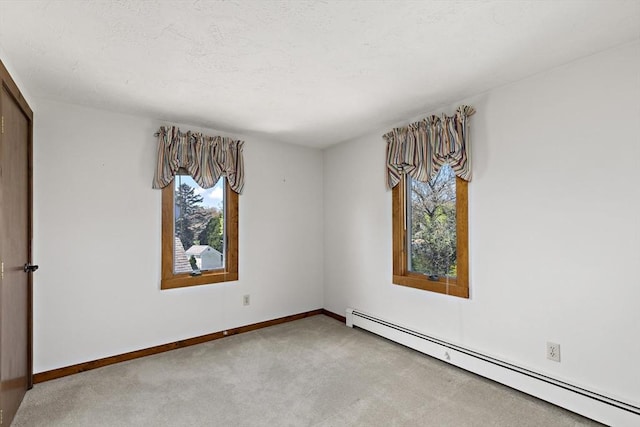 unfurnished bedroom featuring carpet floors, a baseboard radiator, and baseboards