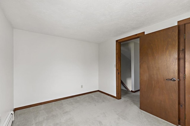 unfurnished room with baseboards, baseboard heating, and carpet flooring