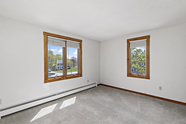 carpeted empty room with baseboards and a baseboard heating unit
