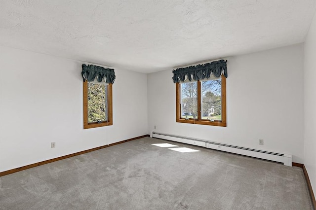 unfurnished room featuring baseboards, carpet flooring, a textured ceiling, and a baseboard heating unit