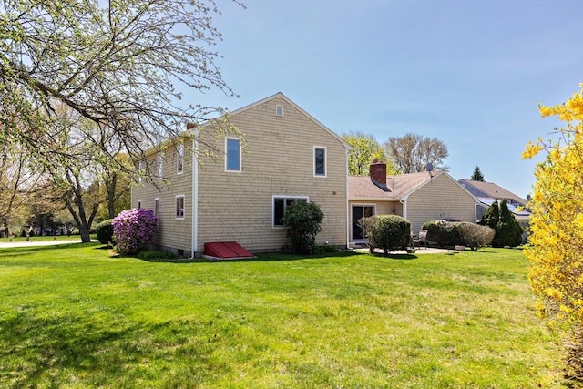 view of side of home with a lawn