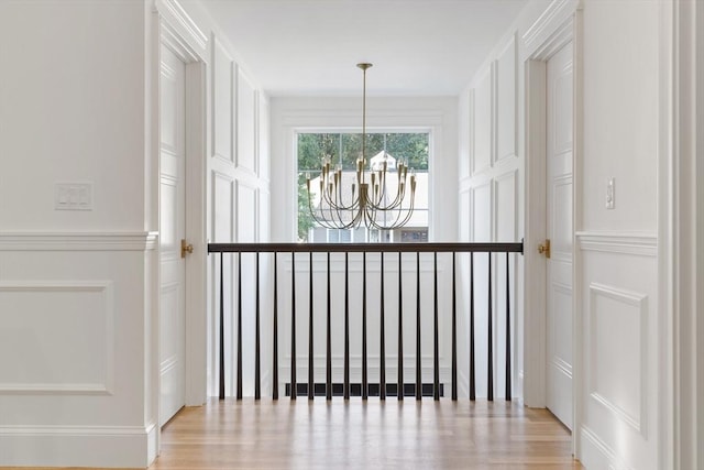 interior space with a notable chandelier and light hardwood / wood-style floors