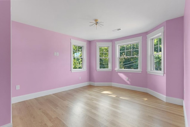 unfurnished room with ceiling fan and light wood-type flooring