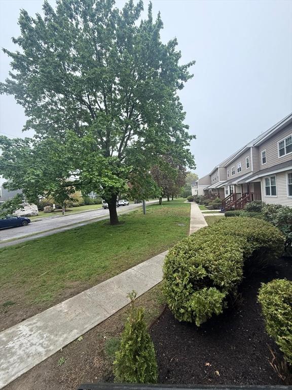 view of home's community with a lawn