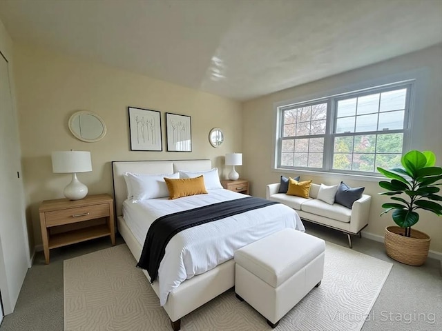bedroom featuring baseboards and light colored carpet