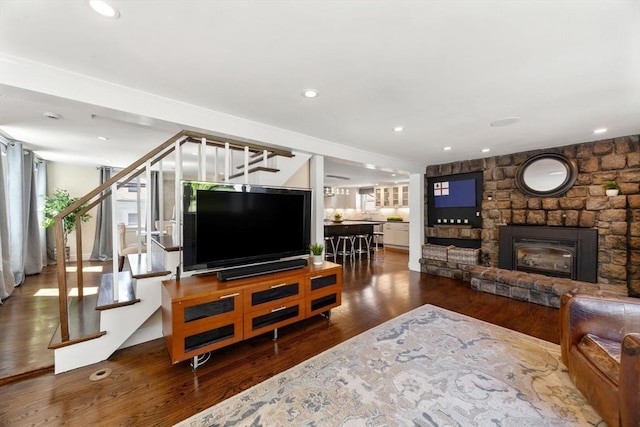 living room with stairway, a fireplace, wood finished floors, and recessed lighting
