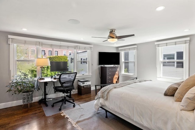 bedroom with multiple windows, wood finished floors, an office area, and recessed lighting