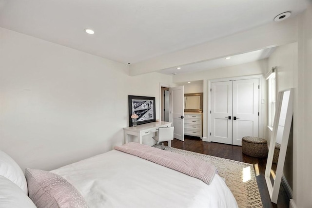 bedroom with dark wood-style flooring, a closet, recessed lighting, and beam ceiling