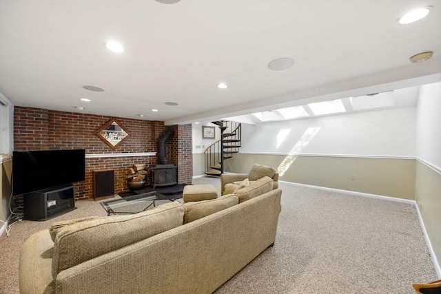 living area featuring a wood stove, carpet flooring, baseboards, stairway, and recessed lighting
