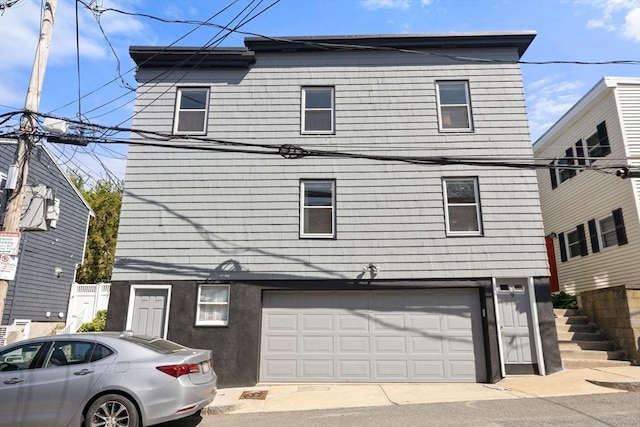 view of front of home with an attached garage and stucco siding