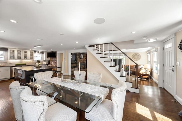 dining space featuring stairs, recessed lighting, dark wood-style floors, and baseboards