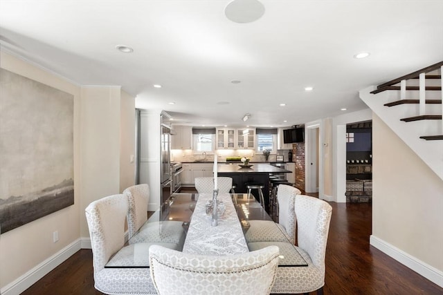 dining space with stairs, recessed lighting, baseboards, and wood finished floors
