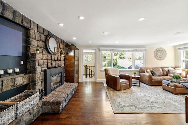 living room with wood finished floors, a fireplace, recessed lighting, and baseboards