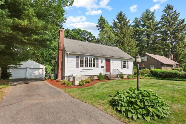 45 Donamor Ln, East Longmeadow, MA 01028 - view of front of house with an outbuilding, a detached garage, a chimney, a front lawn, and cooling unit