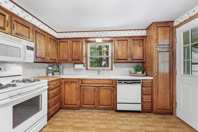 45 Donamor Ln, East Longmeadow, MA 01028 - kitchen with white appliances, a sink, brown cabinets, light countertops, and backsplash