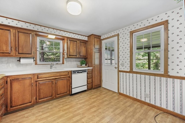 45 Donamor Ln, East Longmeadow, MA 01028 - kitchen featuring white dishwasher, a sink, wallpapered walls, and brown cabinetry
