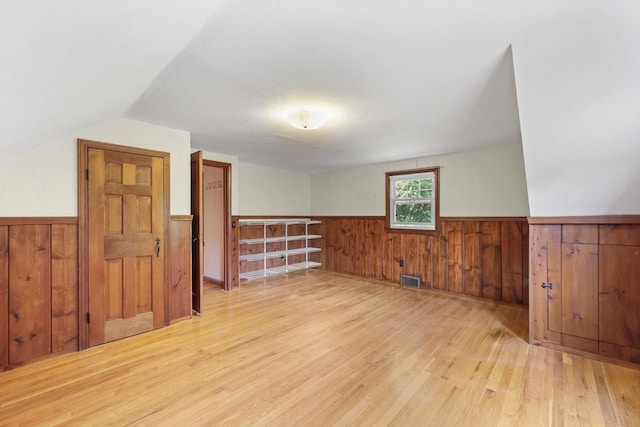 45 Donamor Ln, East Longmeadow, MA 01028 - additional living space with a wainscoted wall, wood finished floors, wood walls, and lofted ceiling