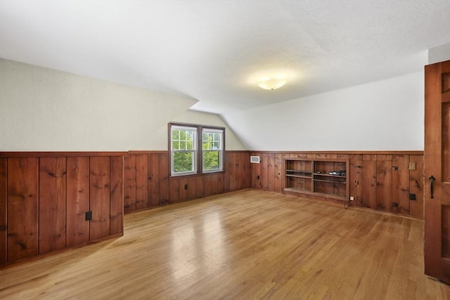 45 Donamor Ln, East Longmeadow, MA 01028 - additional living space featuring wood walls, wood finished floors, a wainscoted wall, and lofted ceiling